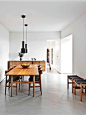 White clean minimalist dining room, love the concrete floor: