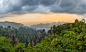 Pagoda on the hill sunset panorama with rocky mountains in the background and forest in the foreground,  Zhangjiajie national park, Hunan province, China