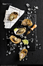 Fresh oysters on a black stone plate top view - stock photo