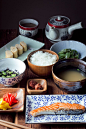 A traditional Japanese breakfast, which includes fish, rice, miso soup, and assorted vegetables.: 