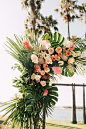 wedding ceremony arch tropical flowers