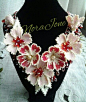 A netted necklace with red hot flowers...: 