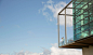 Men standing on balcony of glass bump out against blue sky by Caia Images on 500px