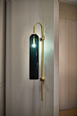 Float is a minimalist light from Articolo that's reminiscent of Hollywood glamour with sleek, elongated proportions, striking colored glass and brass stems.