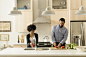 Mixed race couple cooking together in kitchen by Gable Denims on 500px