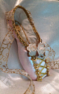 pink and gold decorative pointe shoe designed to mimic the lace up bodice of many traditional ballet costumes