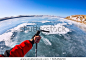 First person view gopro stick in his hand on the ice of Lake Baikal.