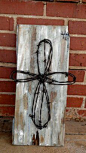 Old barb wire Cross on painted old barn wood