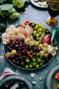 A large plate of grapes and olives.