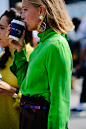 Woman wearing green shirt and earring