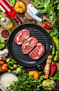 Ingredients for cooking healthy meat dinner. Raw uncooked beef steaks with vegetables, rice,...