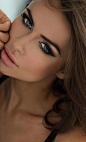 Brunettes rock the smoky eye and confident eyebrows. Always looks amazing with a pinkish orange lip and a dark tan.: 