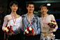 Patrick Chan of Canada with the gold medal celebrates on the podium with silver medalist Yuzuru Hanyu of Japan and bronze medalist Nobunari Oda of...