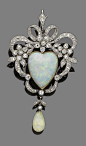 An opal and diamond brooch/pendant, circa 1890.  The openwork cartouche of ribbon and floral design, set throughout with cushion-shaped, old brilliant and single-cut diamonds, and to the centre with a heart-shaped cabochon opal, suspending an opal drop, d