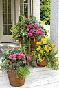 Pots Bursting with Blooms - 25 Easy Spring Decorating Ideas We’re DIYing this Weekend - Southernliving. Adorn your entryway with copious blooms in containers to welcome spring. Cluster three containers together in varying sizes to create this look.