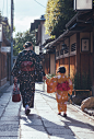 Girl and mother walk in the street, Japan