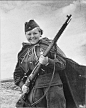 Sniper Maria Kuvshinova smiles at the photographer while clasping her Mosin Nagant sniper rifle. With several dozens confirmed kills of enemy soldiers and officers, Kuvshinova earned the Order of Glory of the USSR, third class. May 1944.