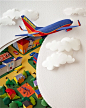 Paper sculpture image of a SouthWest Airlines plane cutting through the sky and clouds