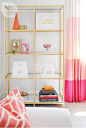 The gold étagère open shelves create a revolving display space for everything from personal photos to favourite books. Pink ombré drapes ...