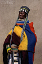 Ndebele Woman in Traditional Dress  Original caption:Annah Banaye Ntuli displays her imlingakobe: a special, long strand of beads draped from the head which means the Trail of Tears. Imlingakobe are started when a male child is born and worked on until hi