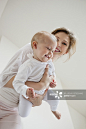 Woman playing with her daughter and smiling