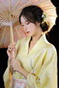 woman in white robe holding umbrella