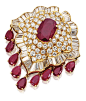 RUBY AND DIAMOND PENDANT-BROOCH, VAN CLEEF & ARPELS, NEW YORK, CIRCA 1980.  Of domed form, centering a cushion-shaped ruby weighing 8.17 carats and supporting a fringe of 9 pear-shaped rubies weighing 8.61 carats, completed by 67 pavé-set round diamon