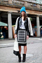 Love the monochrome tones of the biker jacket and graphic-print skirt. And the cobalt-blue pom-pom hat is an excellent finishing touch.