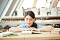 Royalty-free Image: Young woman reading at the library