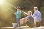 Boy, father and grandfather fishing on wooden dock by Caia Images on 500px