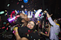 Confetti falling hugging couple enjoying New Year celebration by Hero Images  on 500px