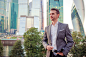 Businessman looking on copy space while standing against glass skyscraper by Dmitry Travnikov on 500px