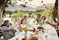 Young couple and guests toasting with champagne during wedding reception in domestic garden by Caia Images on 500px