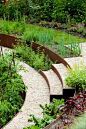 Vegetable garden with semi-circular corten steel raised beds // Nelson Byrd Woltz