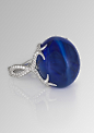 2014-David Morris ring featuring a central 64.55ct blue Burmese double cabochon sapphire with a twisting diamond band.