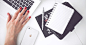 White laptop, female hand, note, pen, phone, desk · Free Stock Photo