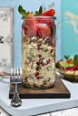Vegan quinoa salad with wallnuts pomegranate and strawberries in a jar