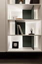 Most clever shelving I have seen lately. The lighting is concealed behind black "L"