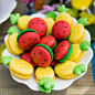 Fabulously cute pineapple and watermelon themed macarons. #tropical_fruit #tiki_party_ideas