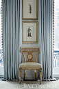 Elegant blue draperies frame an pretty side chair and stacked artwork. - Photo: Werner Straube / Design: Gail Plechaty: 