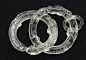 龙纹水晶连环——清，长10.1、厚0.95、口径5.4cm。水晶，洁净透明。此器以一块水晶料，分琢三个连环，其中，两环大，另一环较小，三环均以龙纹为饰，首尾相连成环，环上分琢如意云纹，相当讨喜。
