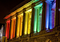 San Francisco Opera House at night, with rainbow colored lights to celebrate gay pride, the weekend of the parade.