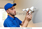 electrical maintenance - electrician change light bulb in wall lamp