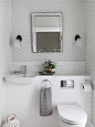 Small transitional powder room photo in London with a wall-mount sink, gray walls and a wall-mount toilet