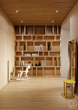 Floor-to-ceiling bookshelves fill the far wall of the library space, otherwise minimally furnished with a charming wood rocking horse by Dutch designer Bo Reudler and a yellow Elios side table by Antonio Citterio.