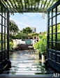 A rooftop garden in New York City is outfitted with French doors and bistro chairs.