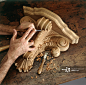 Hands carving sculpture out of wood