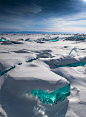 “In March, due to a natural phenomenon, Siberia’s Lake Baikal is particularly amazing to photograph. The temperature, wind and sun cause the ice crust to crack and form beautiful turquoise blocks or ice hummocks on the lake’s surface.”  Photograph by Alex