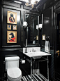 Elegant mosaic tile floor powder room photo in New York with a console sink, a one-piece toilet and black walls
