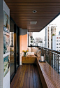 Contemporary Loft Finds The Perfect Balance Between Cool And Elegant The loft has a very cool balcony. It’s small but very inviting and beautiful. The designer used Cumaru wood for the balcony seats and floor and he also designed the roof to match them.  